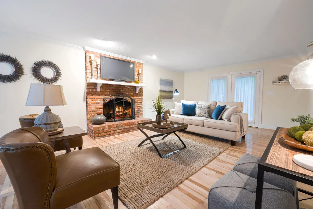 Illustrative stock photo: living room with a brick fireplace, seating and wood flooring