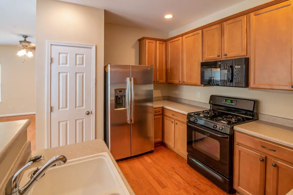 Illustrative stock photo: kitchen with wooden cabinets and stainless steel appliances