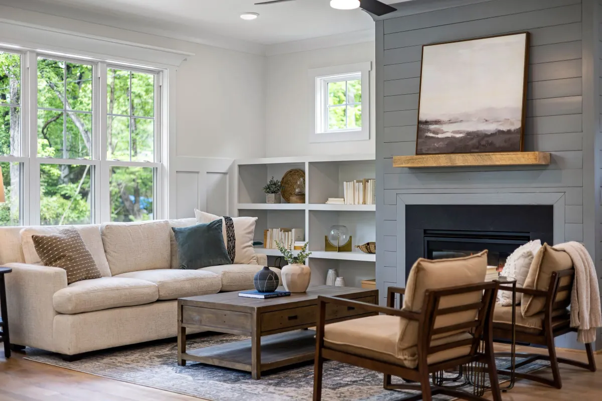 Illustrative stock photo: living room arranged around a fireplace and garden-facing windows