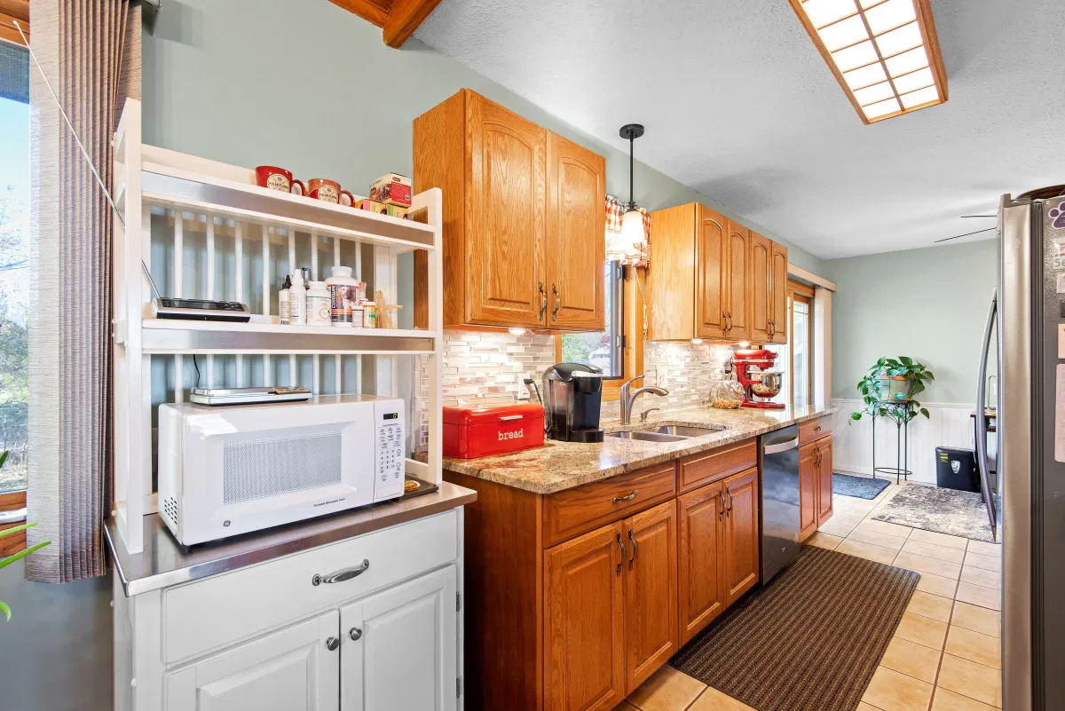 Illustrative stock photo: kitchen with wooden cabinets and light from an overhead skylight