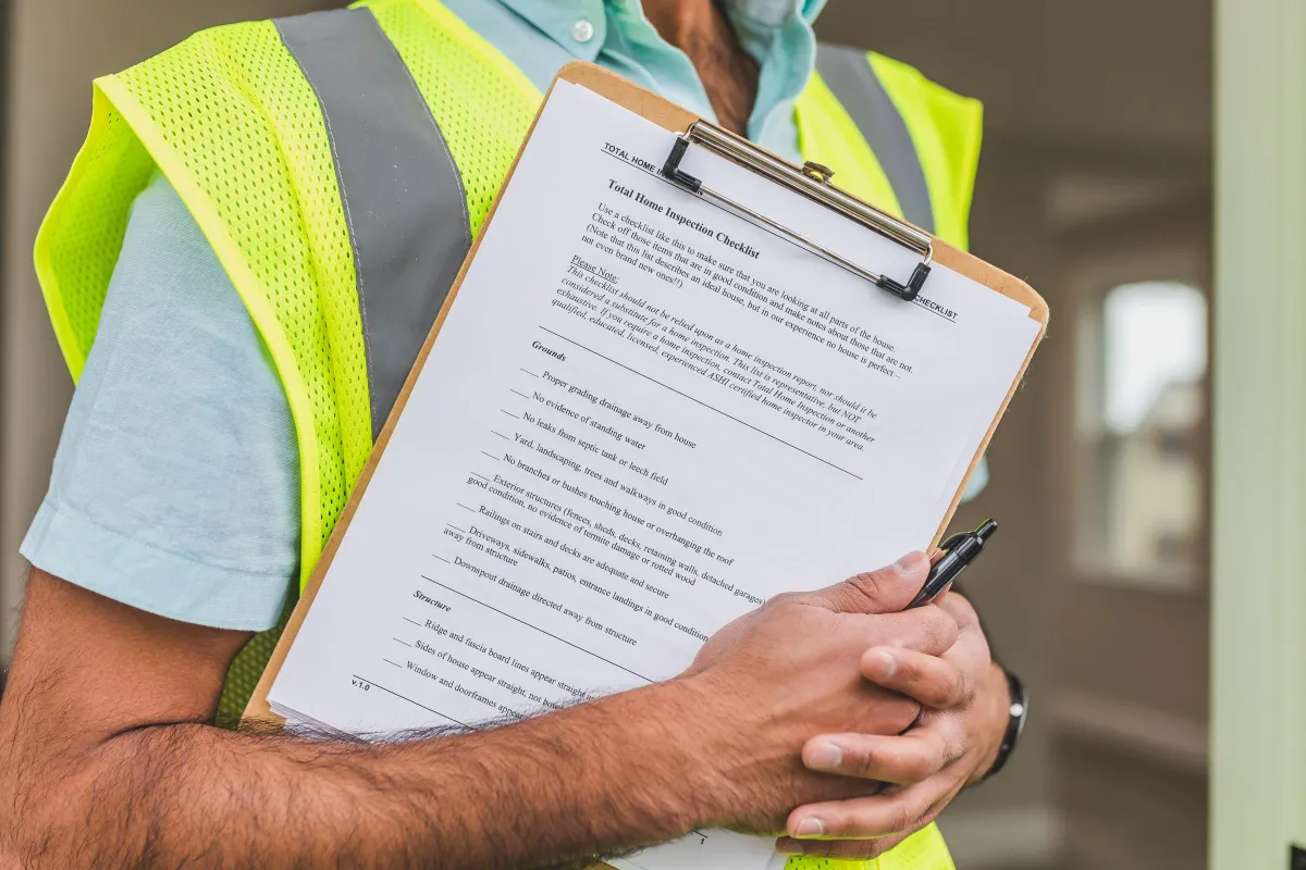 Illustrative stock photo: inspector holding a printed home inspection checklist